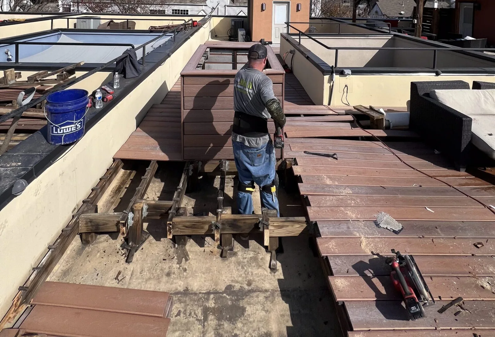 Kick It crew tearing out a rooftop deck in Dallas